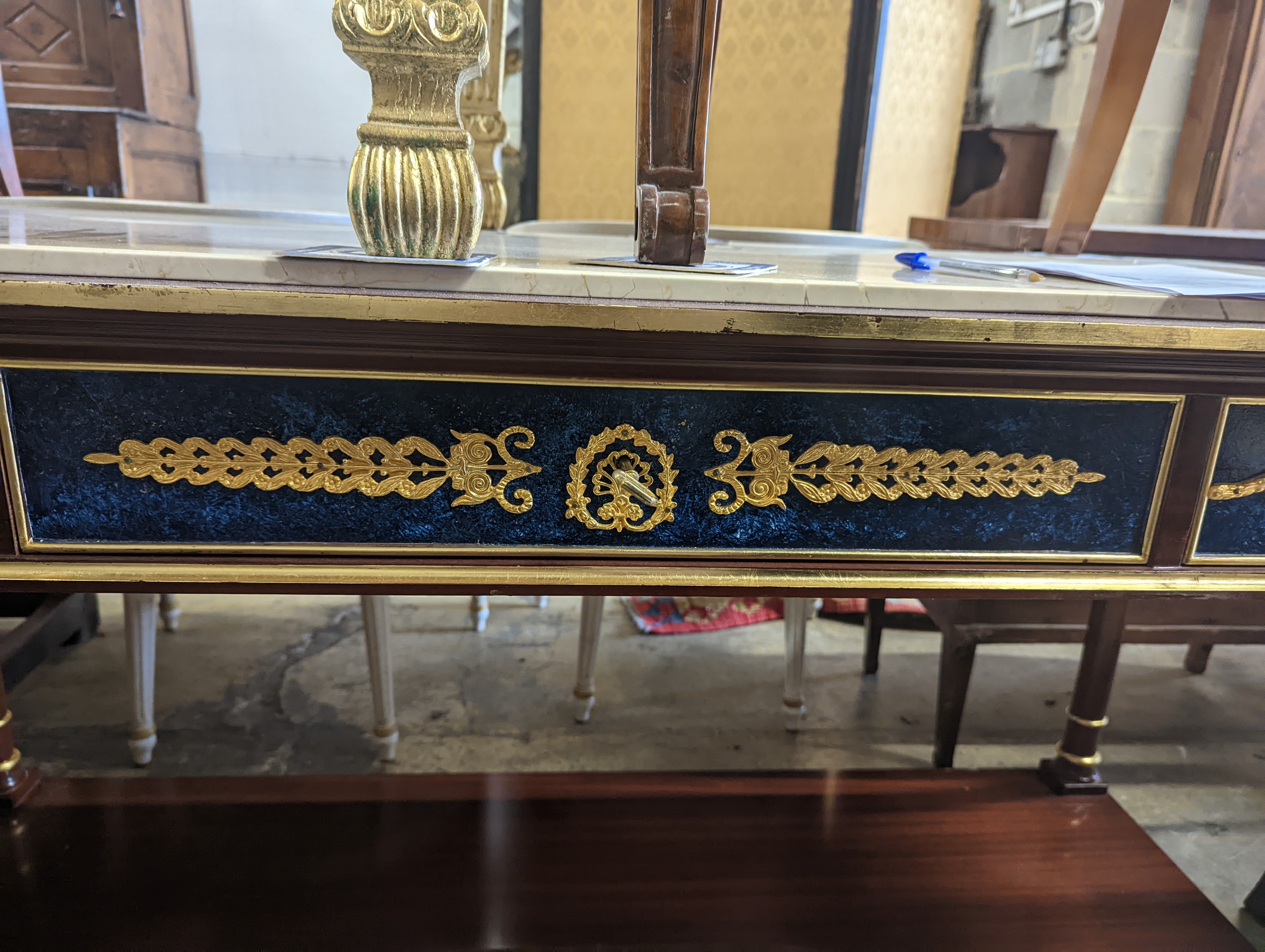 An Empire style parcel gilt and faux malachite marble top console table with concave undertier, width 154cm, depth 65cm, height 80cm